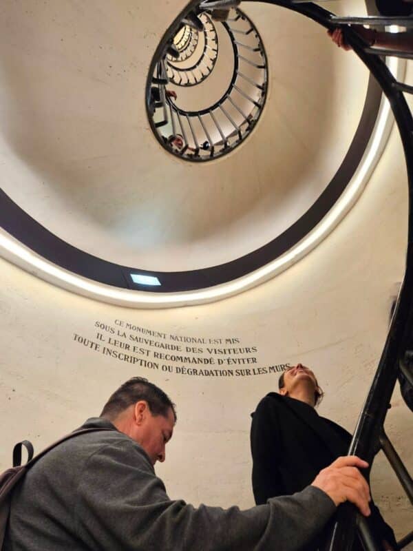 Climbing the stairs inside Arc de Triomphe to the top